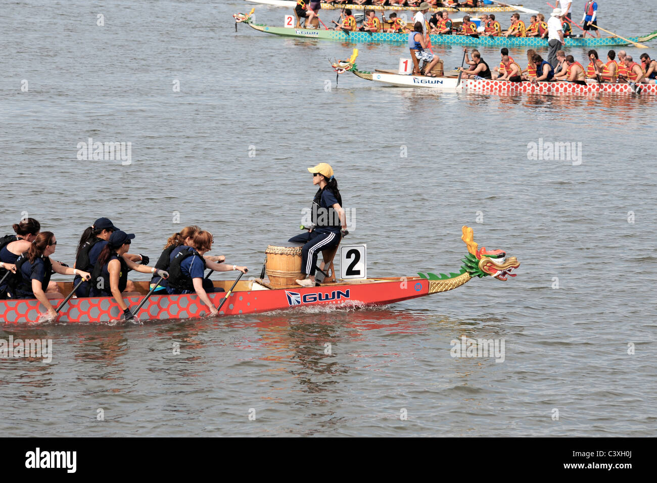Dragon boaters rowing with drummer Stock Photo Alamy