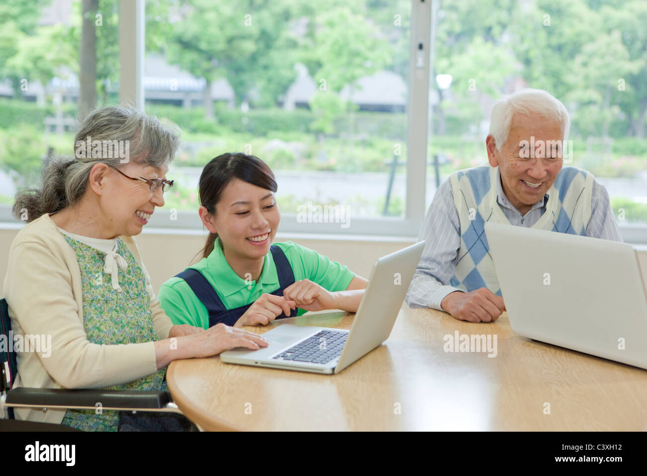 Senior people using laptop, Kanagawa Prefecture, Honshu, Japan Stock Photo