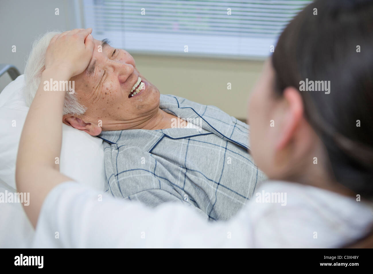 Nurse taking senior man's temperature, Kanagawa Prefecture, Honshu, Japan Stock Photo Alamy