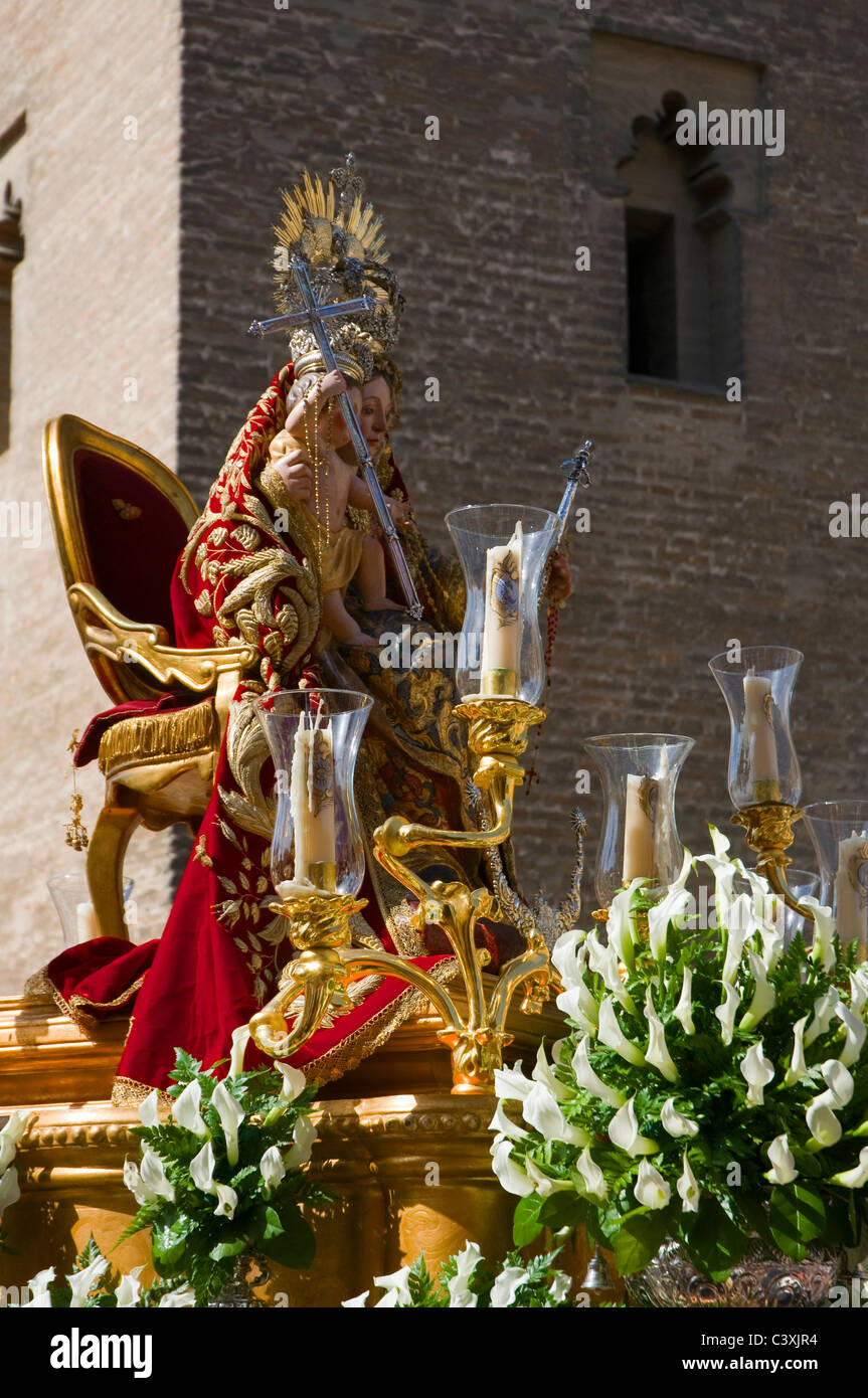 A paso of the Virgin Mary carried in a religious procession past the Cathedral in Seville, Southern Spain. Stock Photo