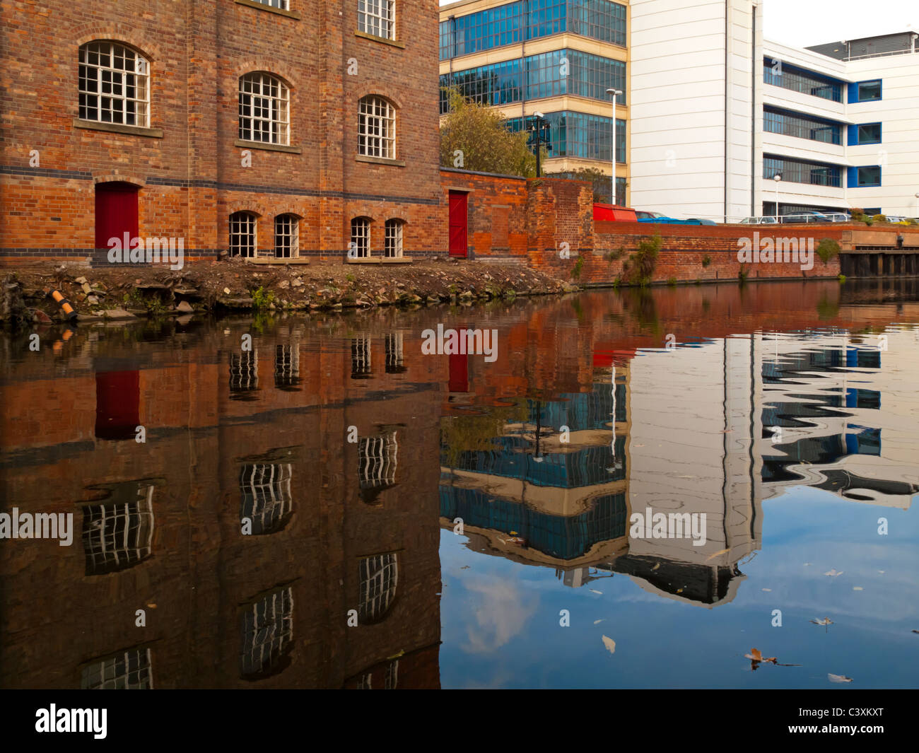 Buildings reflected in Nottingham city centre canal England UK Stock Photo
