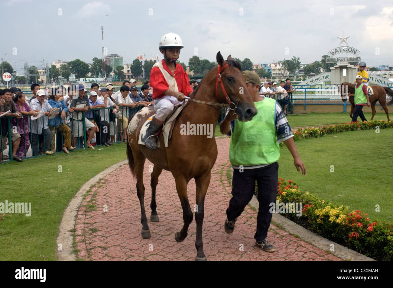 A child jockey on horse is paraded around before the race at the Saigon Racing Club. Stock Photo
