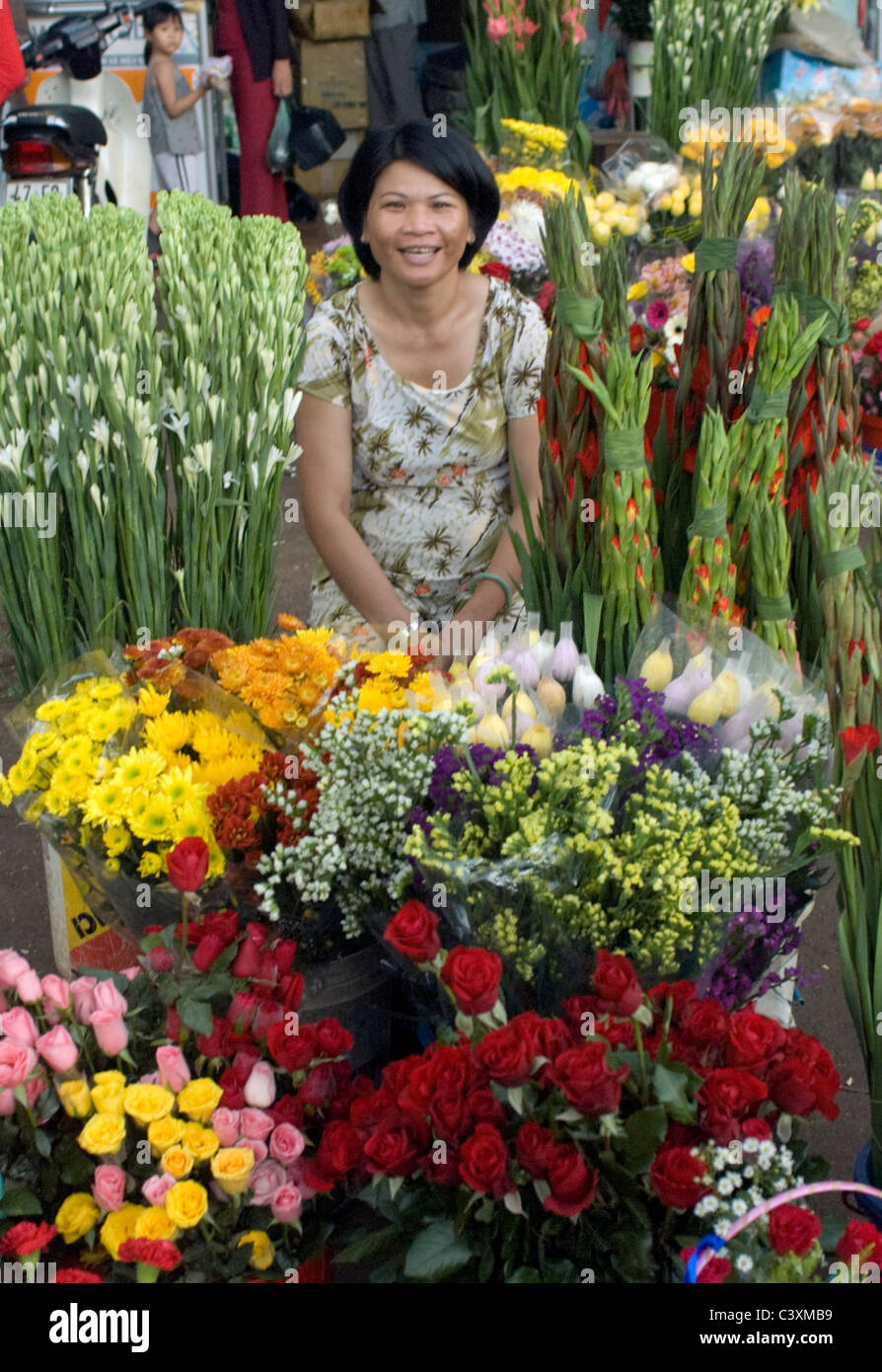 A woman sells flowers in the market Stock Photo Alamy