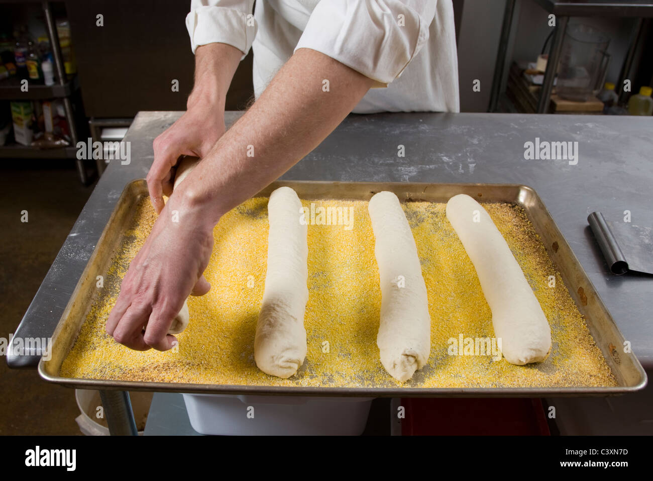 Professional cook preparing fresh bread in a commercial bakery Stock Photo
