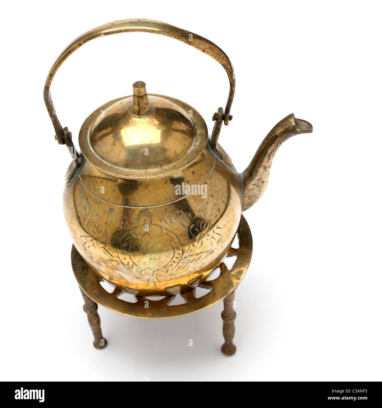 Antique brass teapot on vintage wooden aged table by TONO BALAGUER. Photo  stock - StudioNow