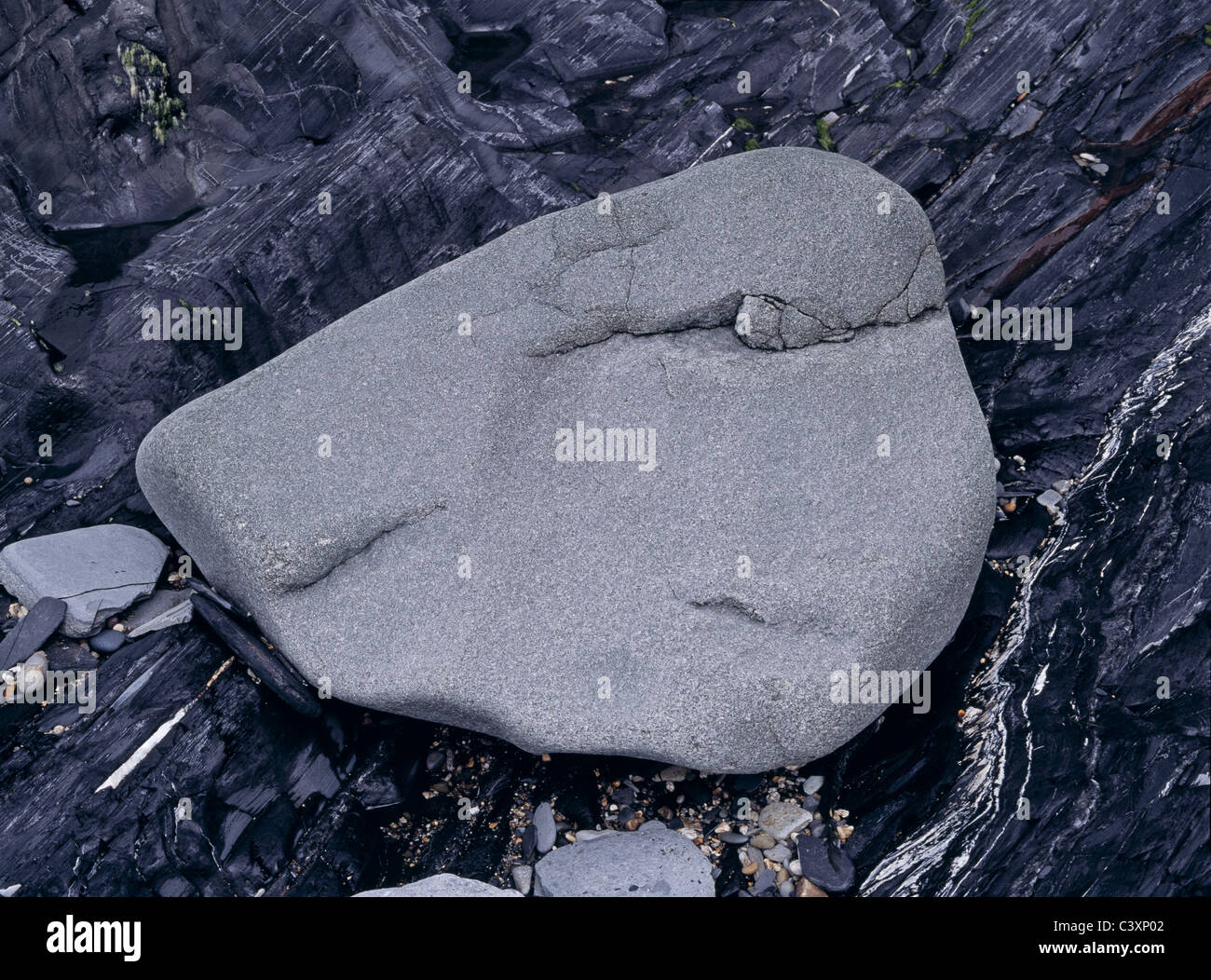 Beach boulder resting on foreshore rocks, Devon, UK Stock Photo - Alamy