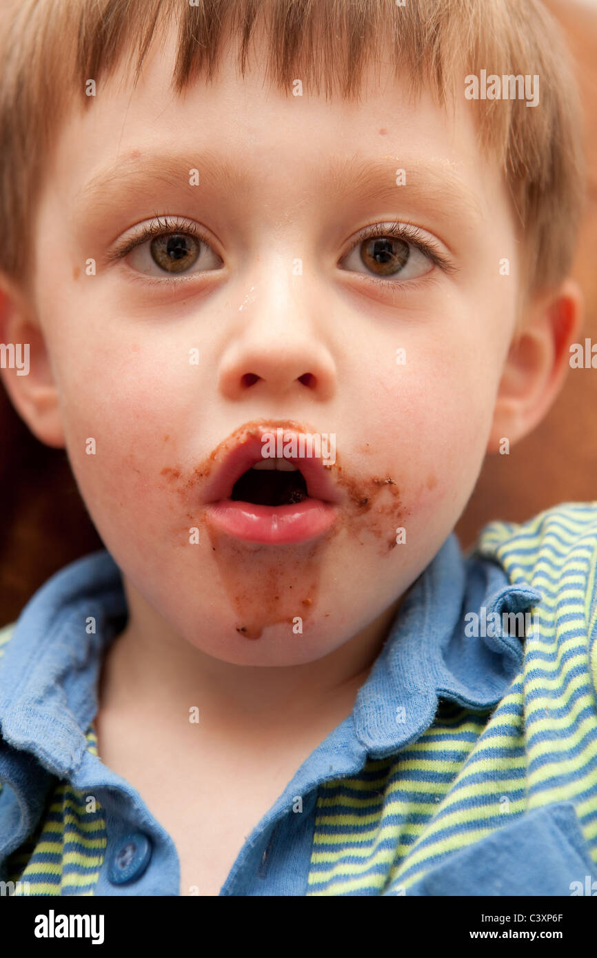 Young boy with chocolate on his face Stock Photo Alamy