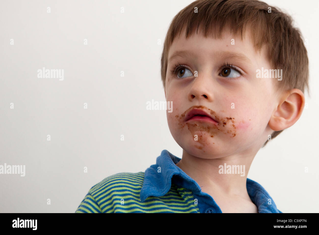 Young boy with chocolate on his face Stock Photo Alamy
