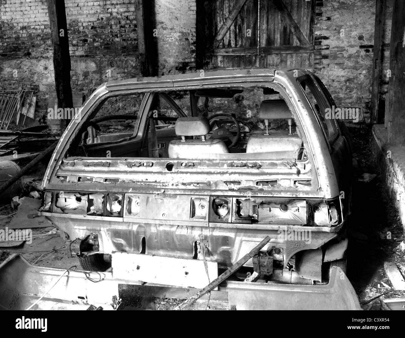 car wreck left neglected in barn wreck, black and white Stock Photo