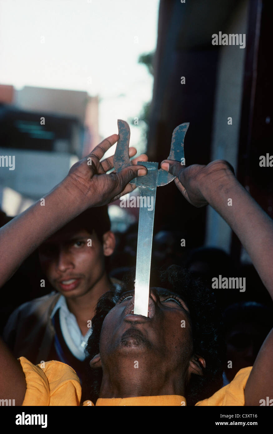 Street performer swallows a sword. New Delhi, India Stock Photo