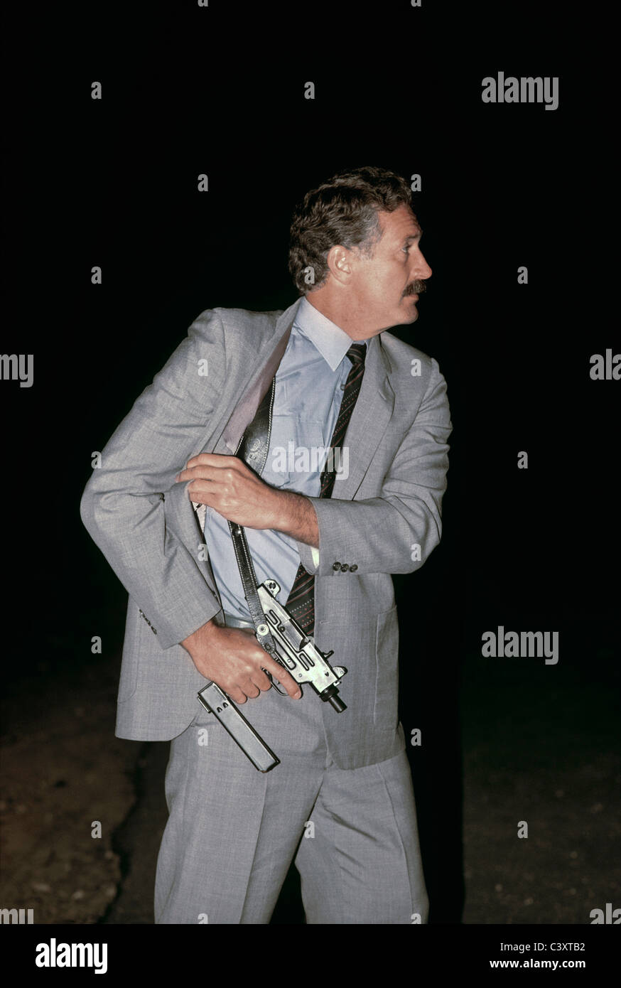 Israeli Secret Service agent draws an uzi pistol from his shoulder