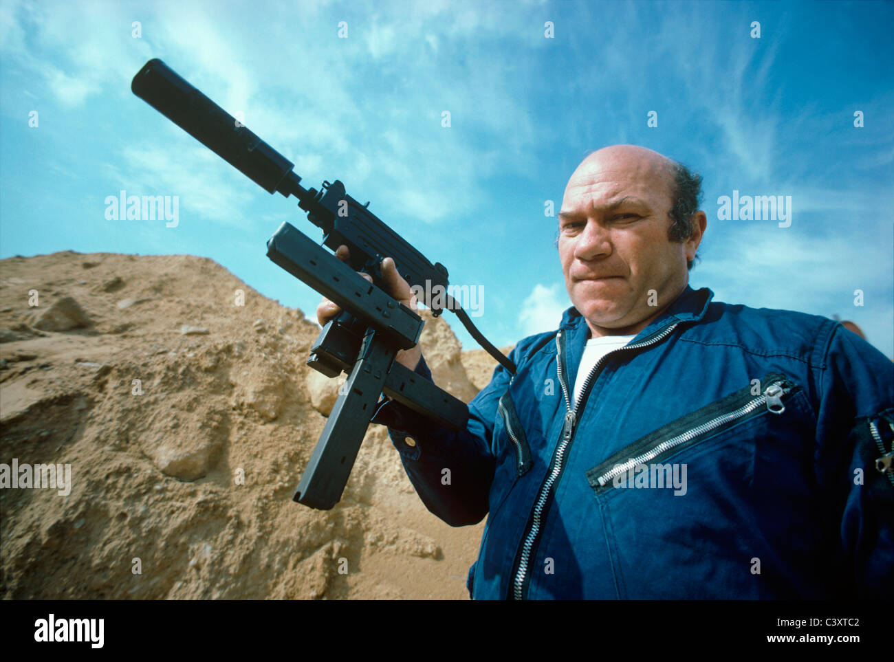 Uziel Gal, the designer and namesake of the Uzi submachine gun, holding a mini-uzi pistol with a crossed magazine. Israel Stock Photo