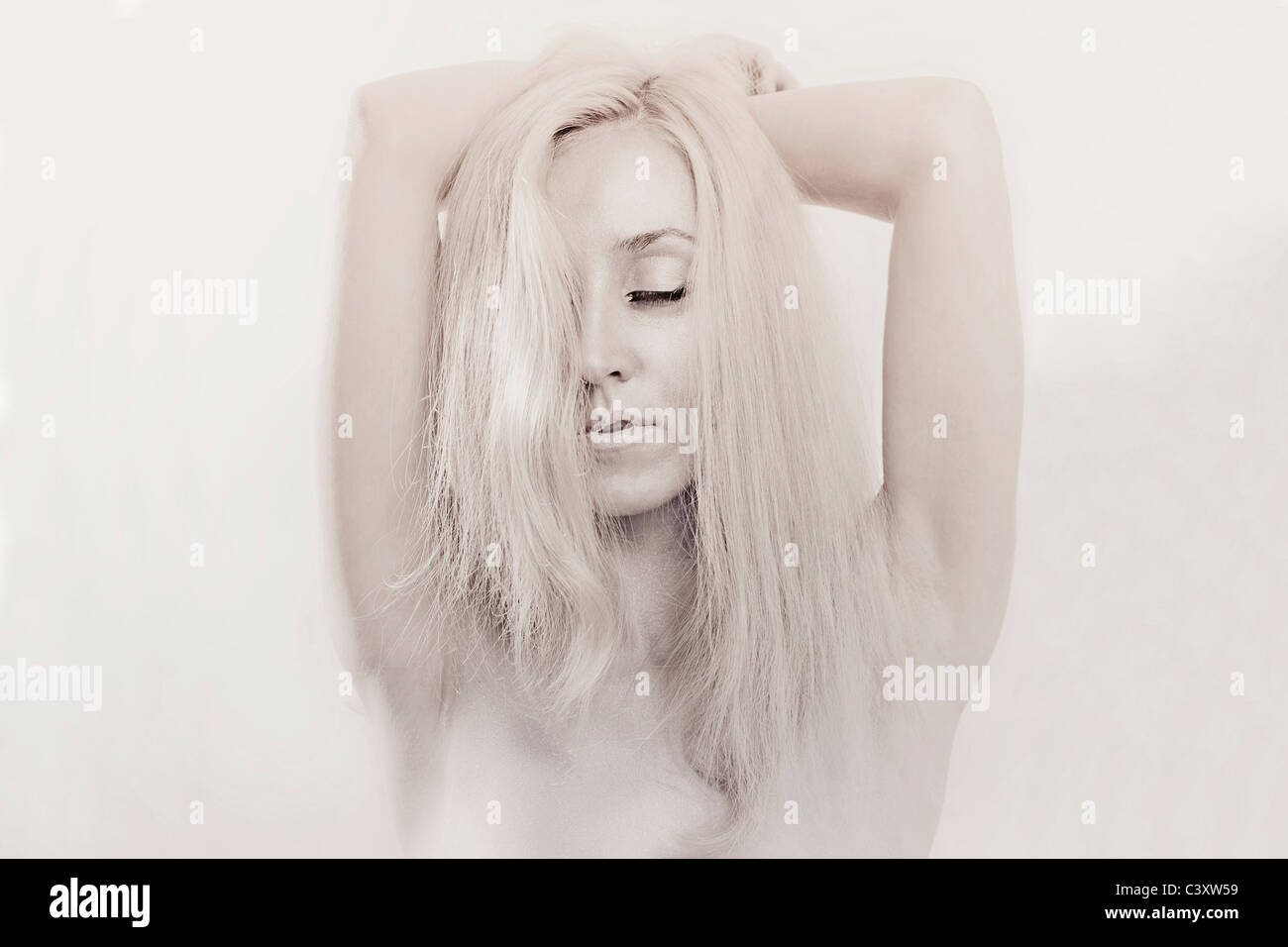 Studio portrait of a beautiful young woman with closed eyes and silver ...