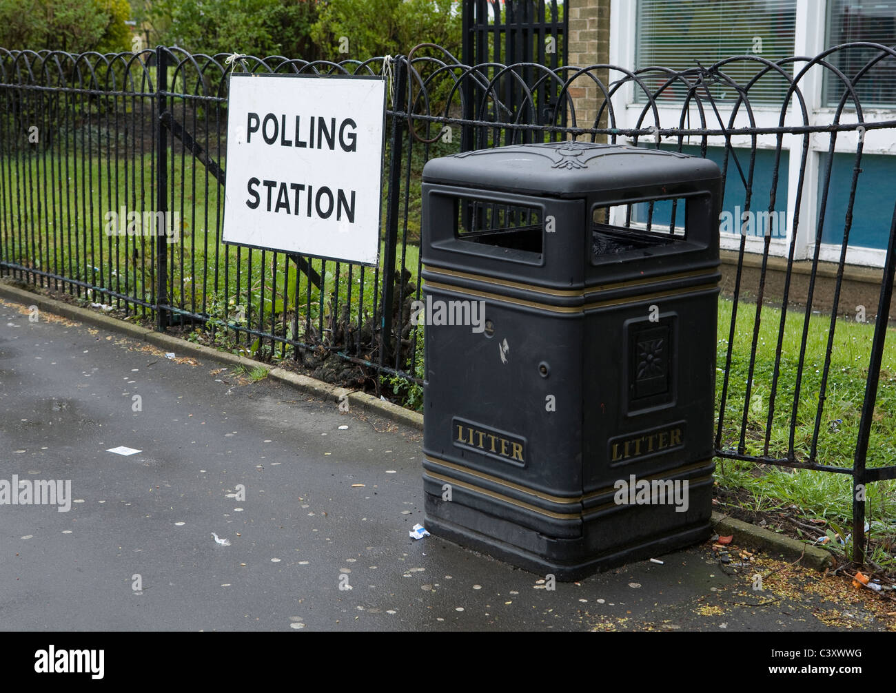 A polling station sign next to a litter bin during a local election Stock Photo