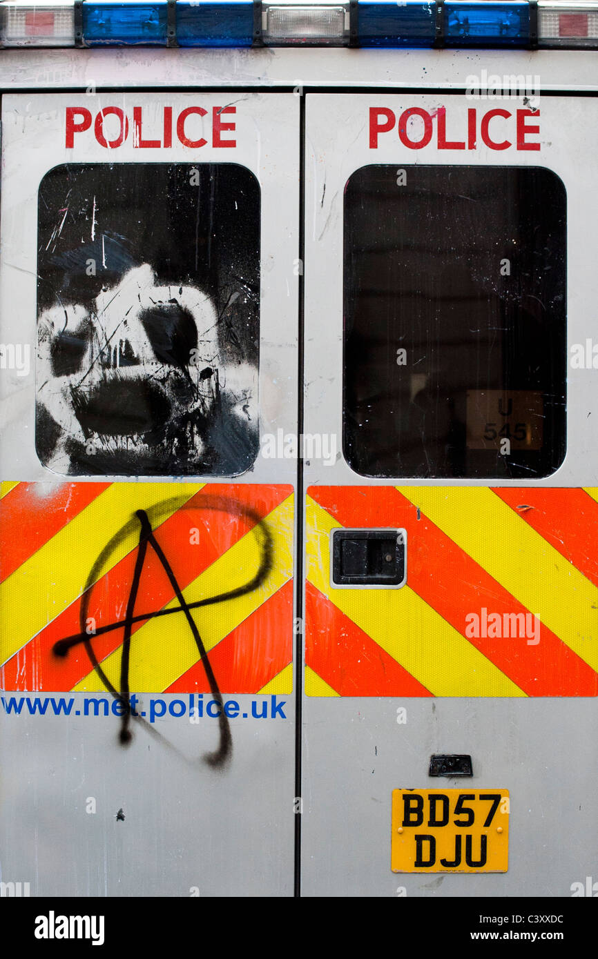 A Police van with the anarchist symbol sprayed onto the back. Stock Photo