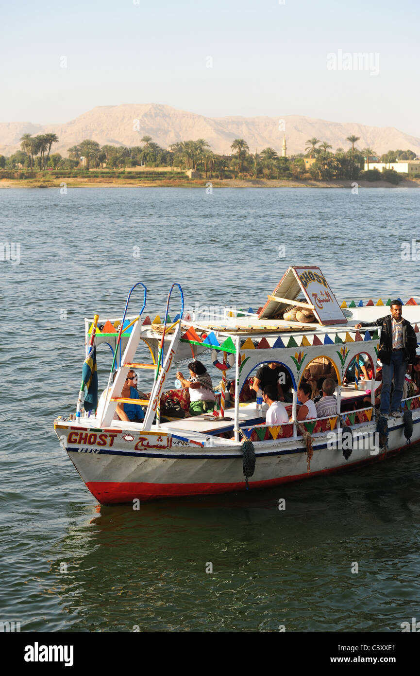 Africa Middle East Egypt Egyptian Luxor Nile River -  a small ferry boat takes people and tourists to the valley of the Kings Stock Photo