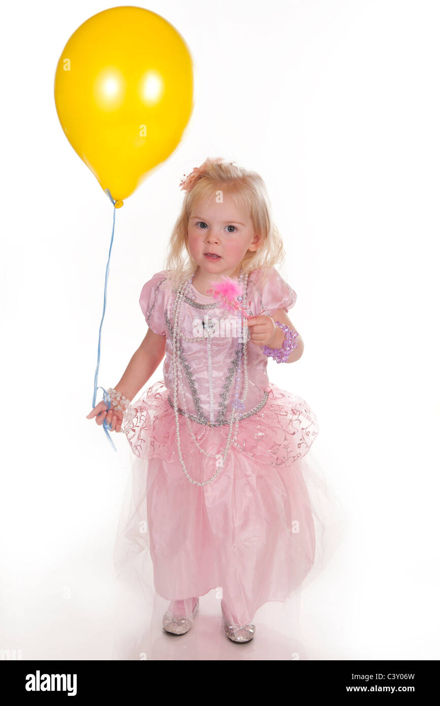 pretty little girl dressed in pink princess dress holding yellow ...