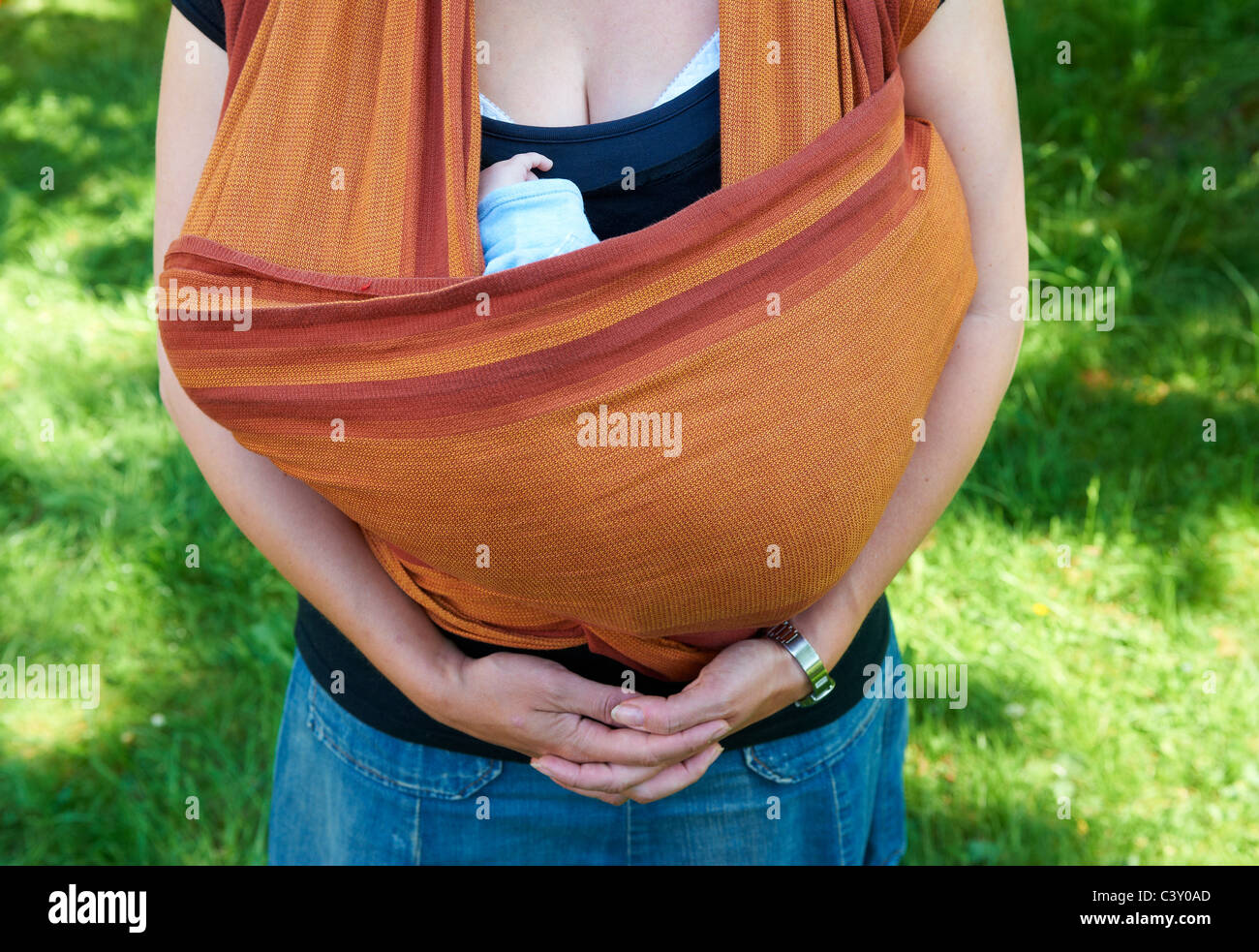 Mother carrying child girl in baby wrap Stock Photo Alamy