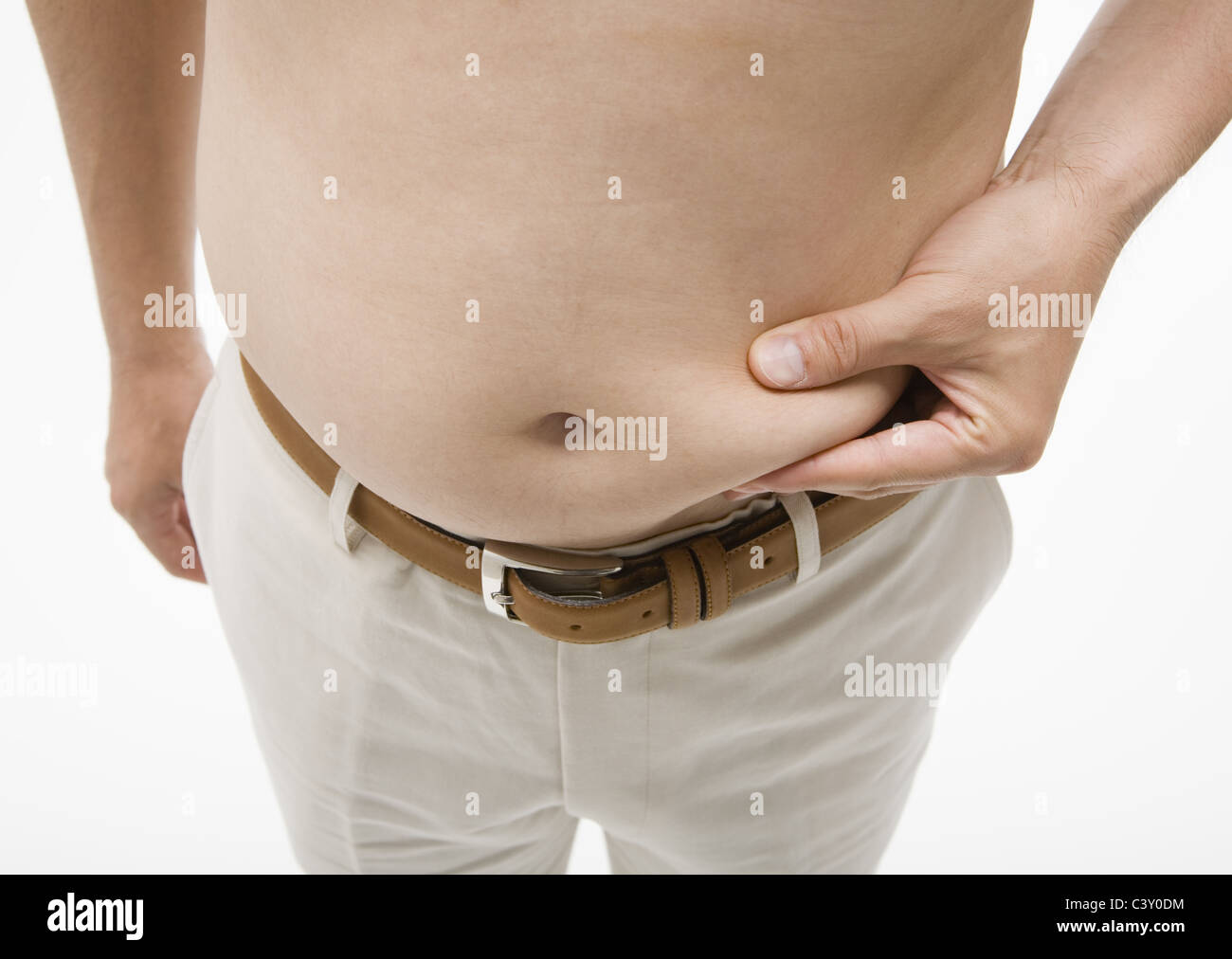 Man pinching his belly Stock Photo
