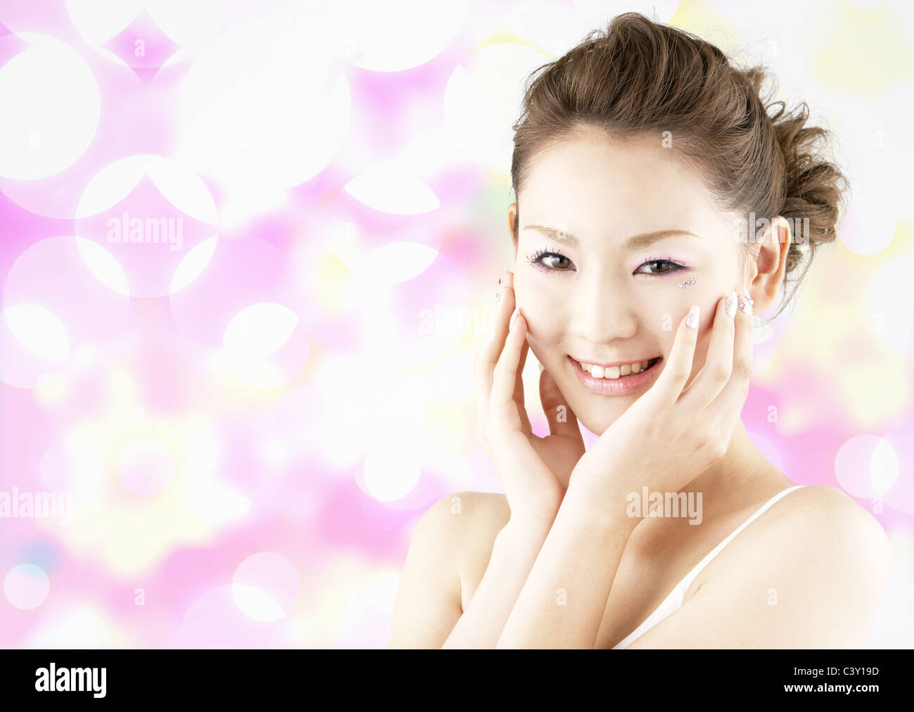 Young woman with hands on cheeks Stock Photo - Alamy