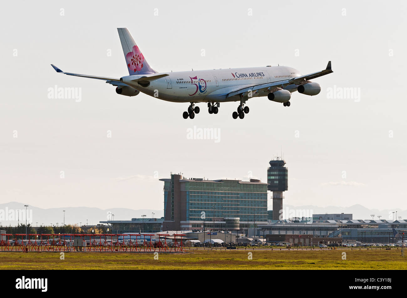 A China Airlines Airbus A340-300 jet airliner on final approach for landing at Vancouver International Airport, Canada. Stock Photo