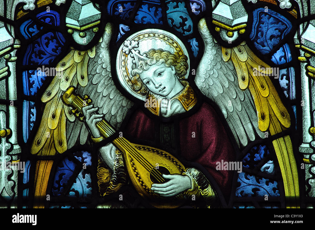 Angel musician stained glass, Holy Trinity Church, Minchinhampton, Gloucestershire, England, UK Stock Photo