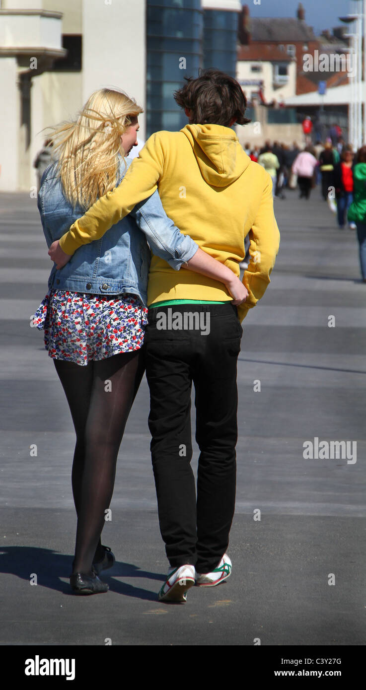 Young couple walking along sea front. Stock Photo