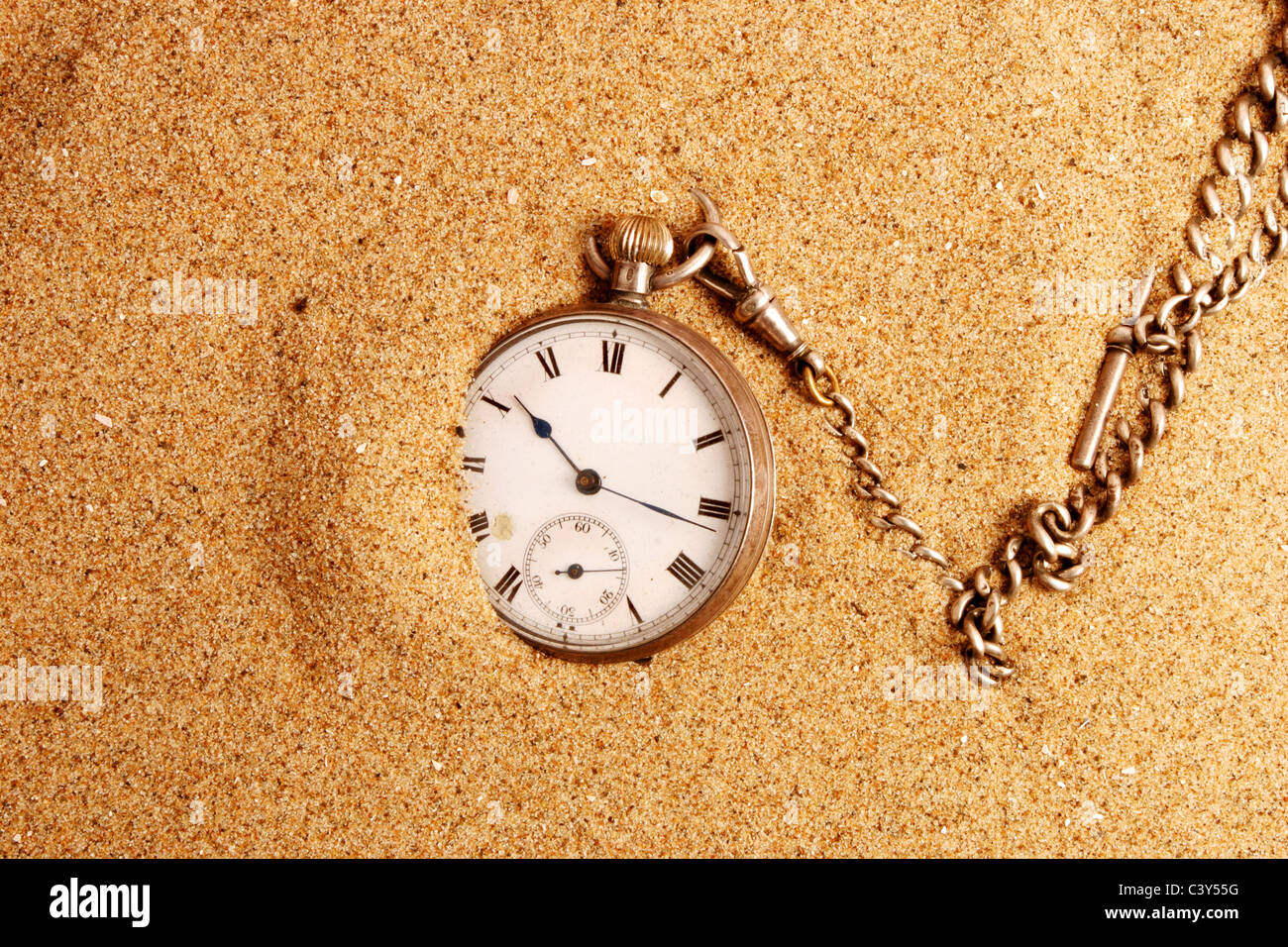 Antique pocket watch on sand Stock Photo