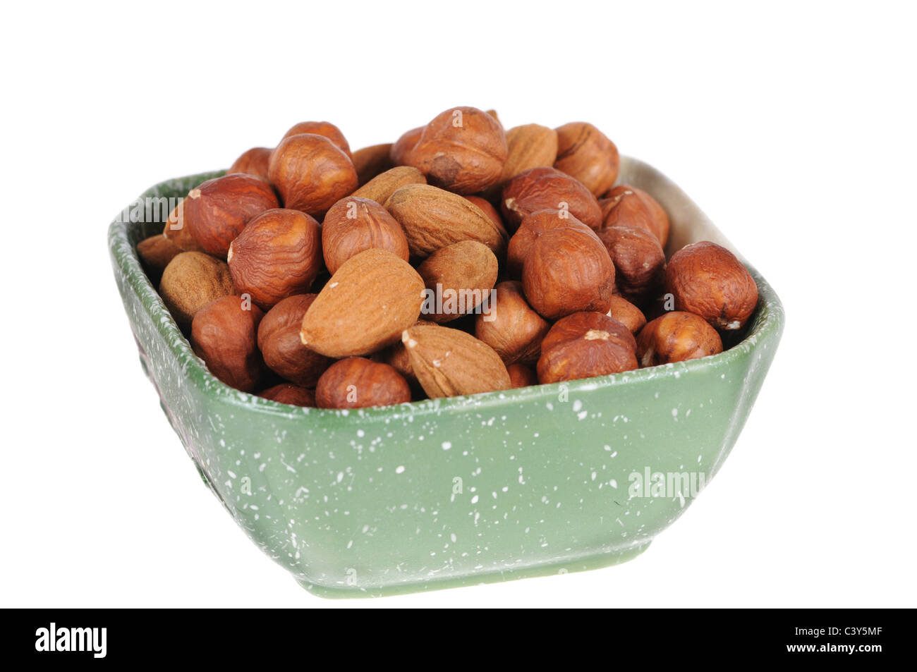 hazelnuts and almond in a cup isolated on white background Stock Photo