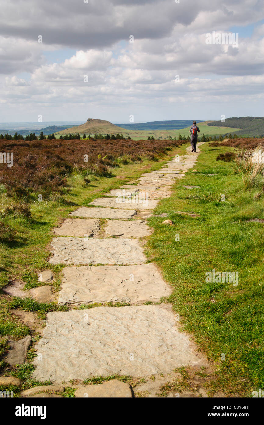 Hiker on Easby moor near Captain Cook's monument with Roseberry Topping ...