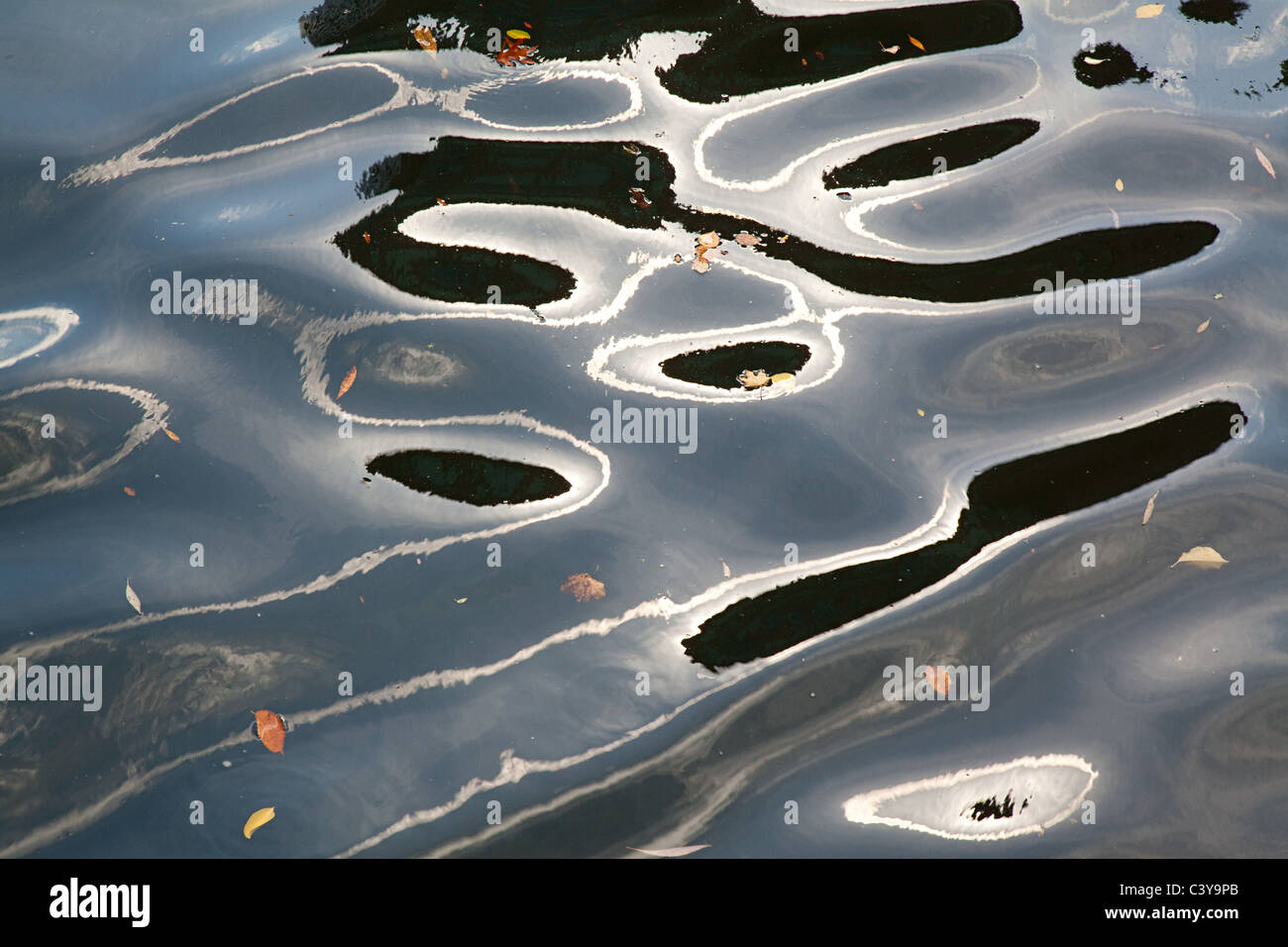 Ripples and reflections on water surface Stock Photo