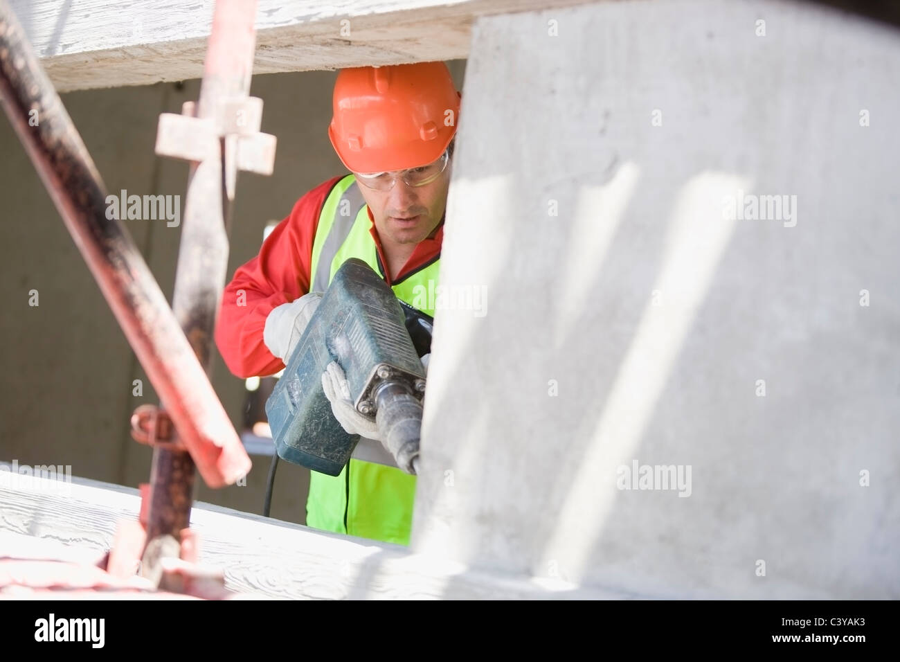 Building worker handling a drill Stock Photo