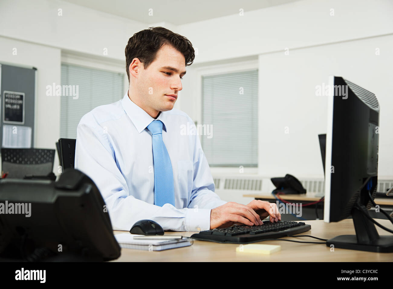 Office worker using computer Stock Photo - Alamy
