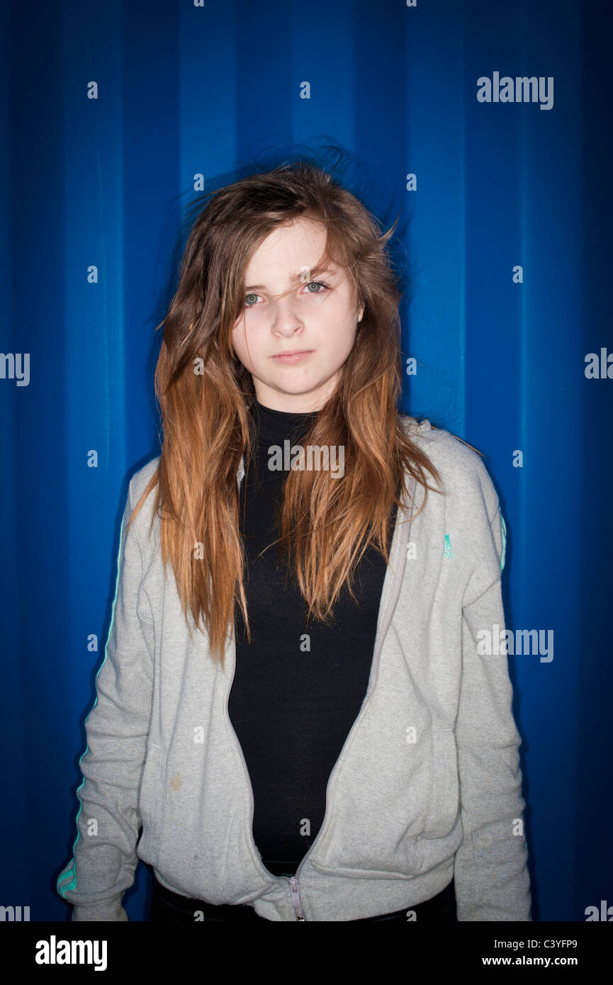 A 12 13 year old teenage girl with attitude - lit using direct harsh on-camera ring flash Stock Photo