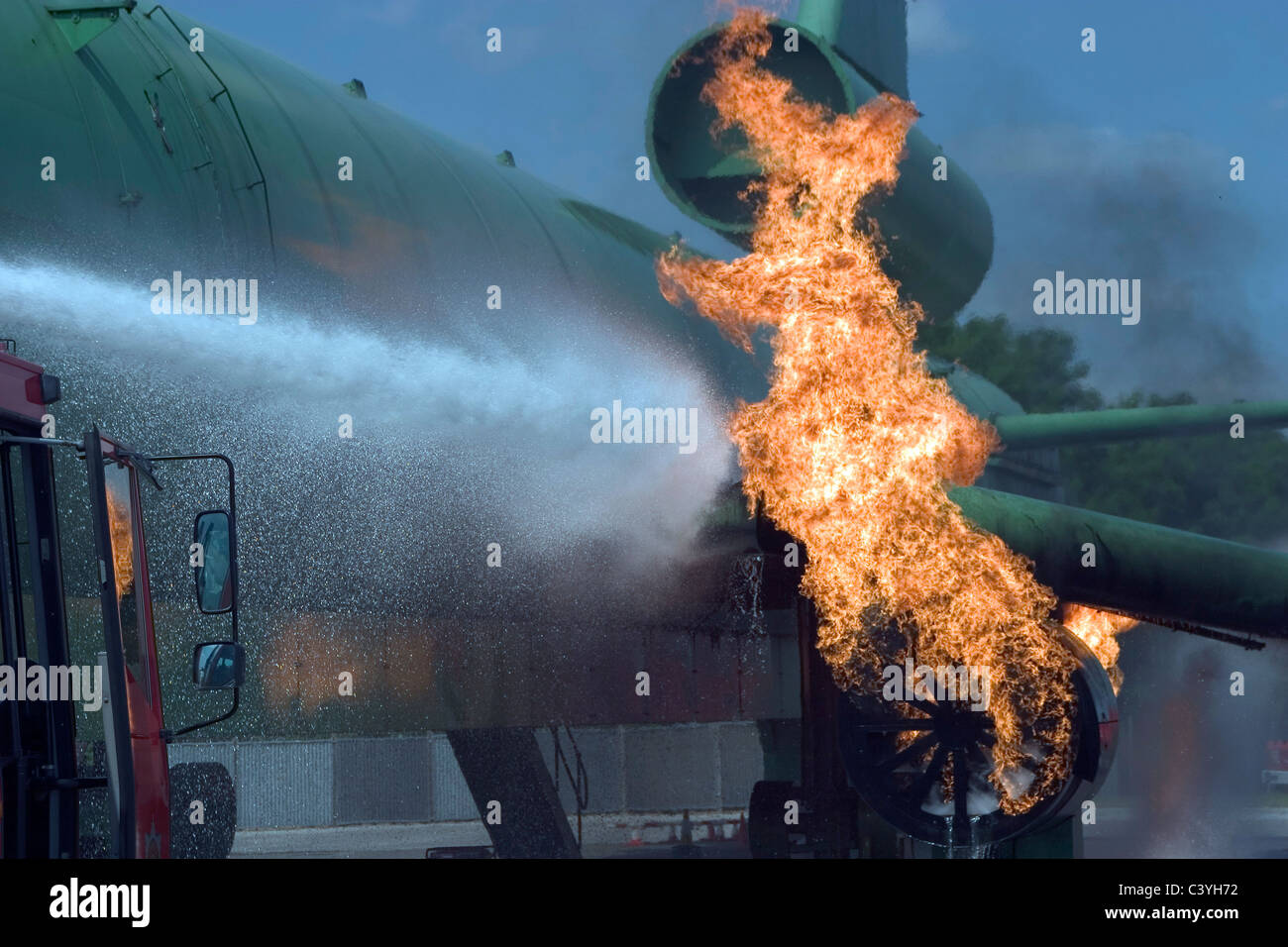 Airport fire service practice extinguishing an engine fire on an aircraft. Stock Photo