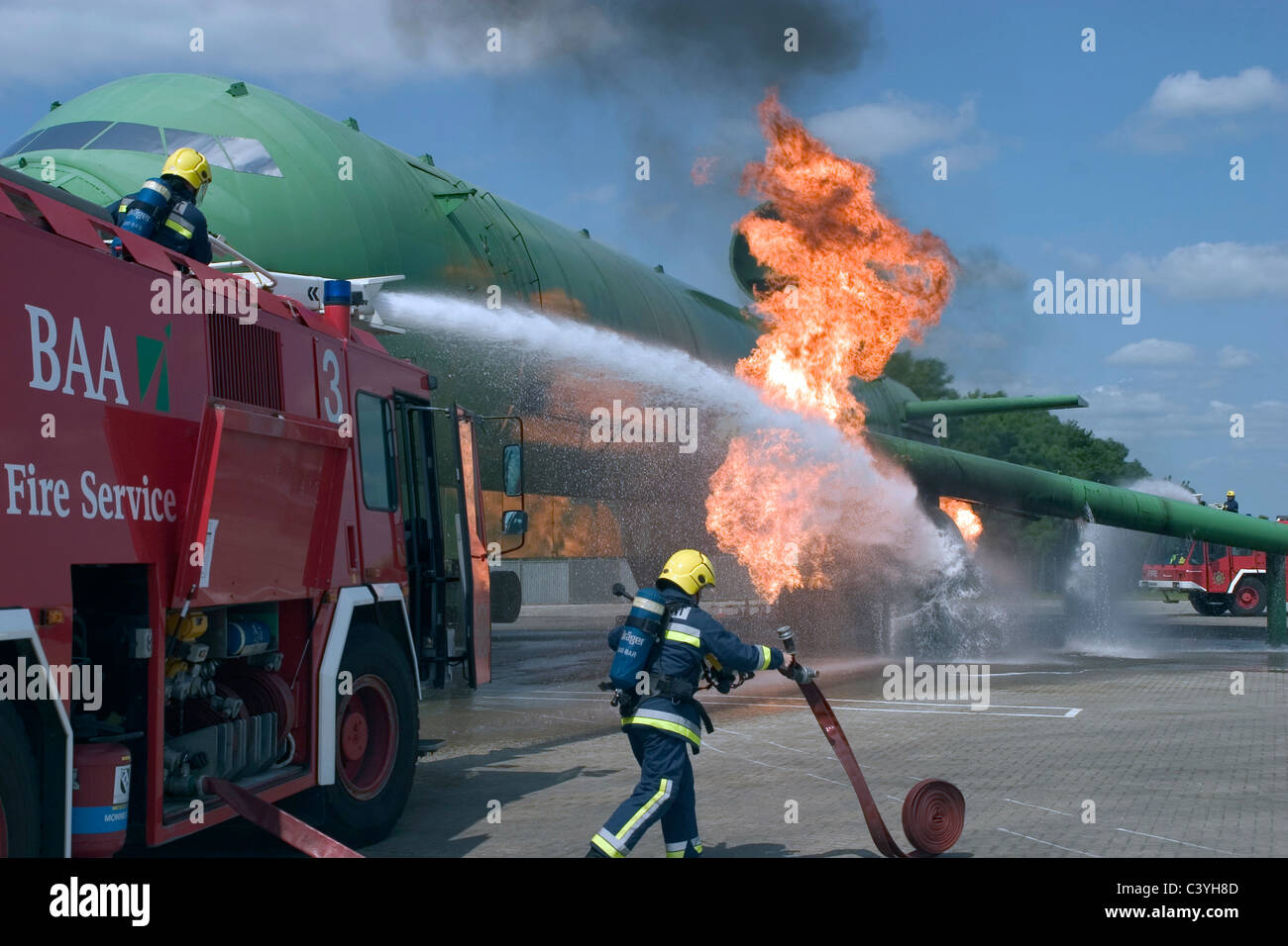 Airport firemen tackle a simulated engine  fire on an aircraft. Stock Photo