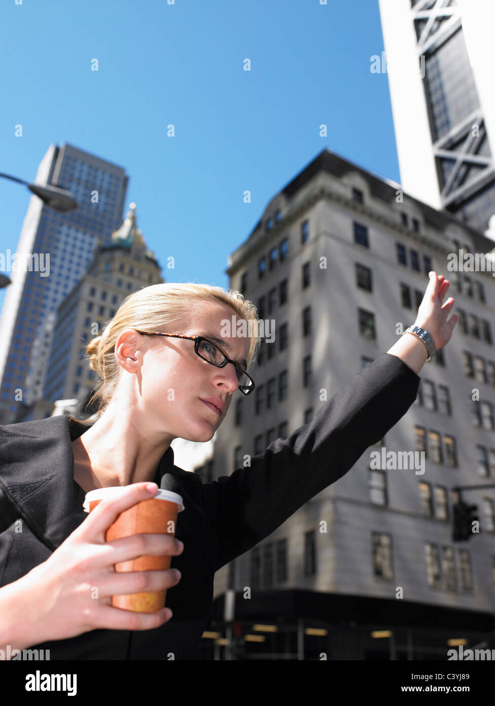 Business woman calling a taxi Stock Photo