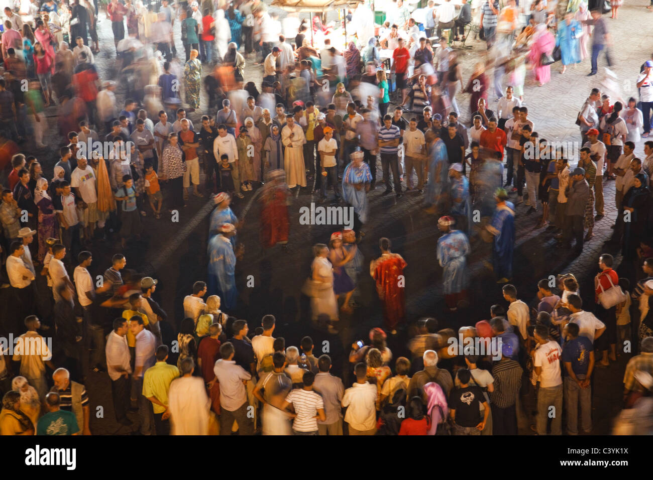 People dance at Djemaa el Fna square at night in the heart of Marrakech, Morocco. Stock Photo