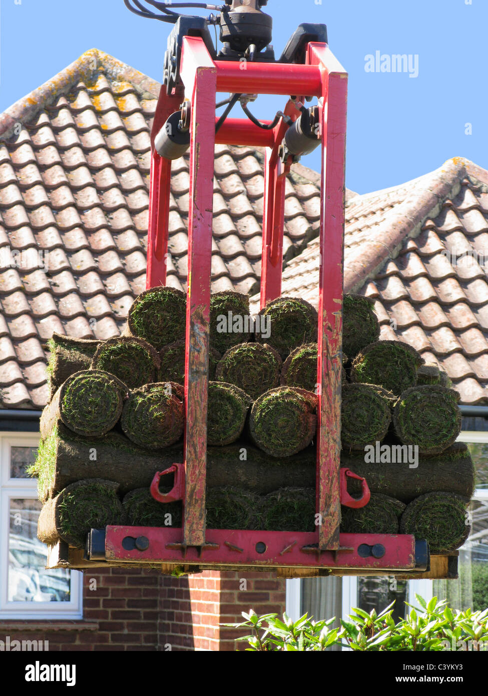 lorry delivering rolls of turf using the grabber Stock Photo