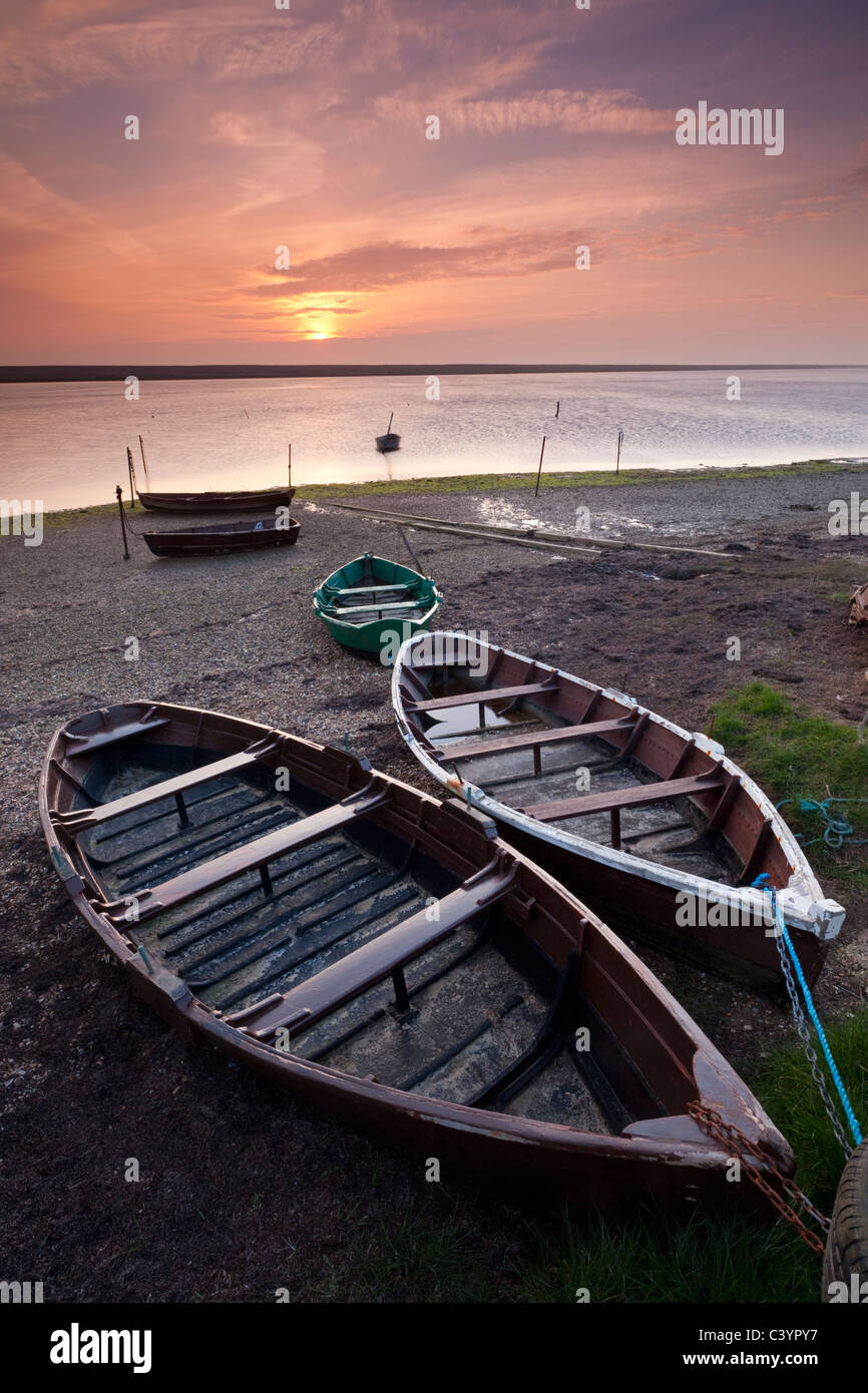 Boats at low tide on the shore of The Fleet lagoon, Chesil Beach, Dorset, England. Spring (March) 2011. Stock Photo