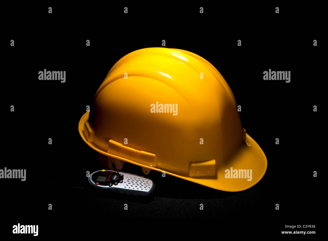 yellow construction style hard hat with radio Stock Photo Alamy