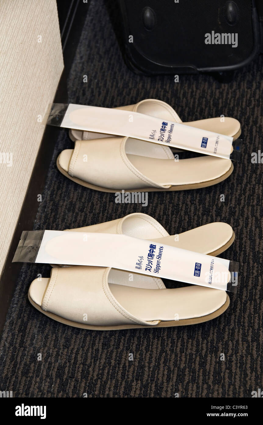 Hotel slippers with disposable slipper sheets are provided for guests