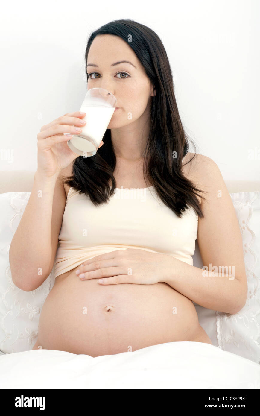 Pregnant woman enjoying glass of milk Stock Photo