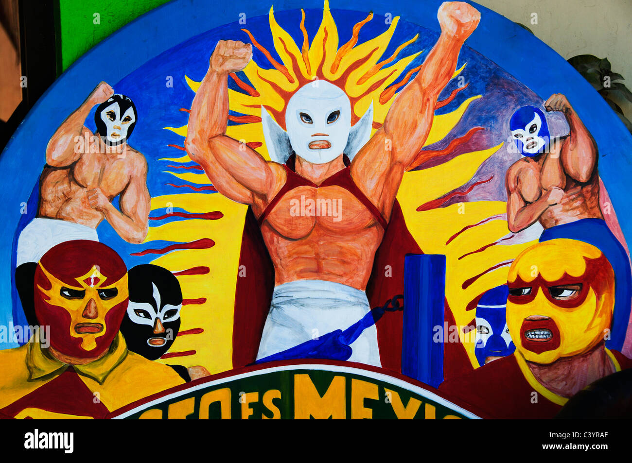 A variety of luchadores wearing colorful masks are painted on a wooden