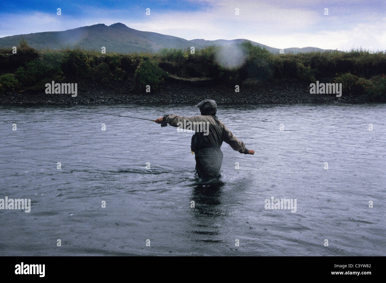 Man fly fishing in the rain Stock Photo Alamy