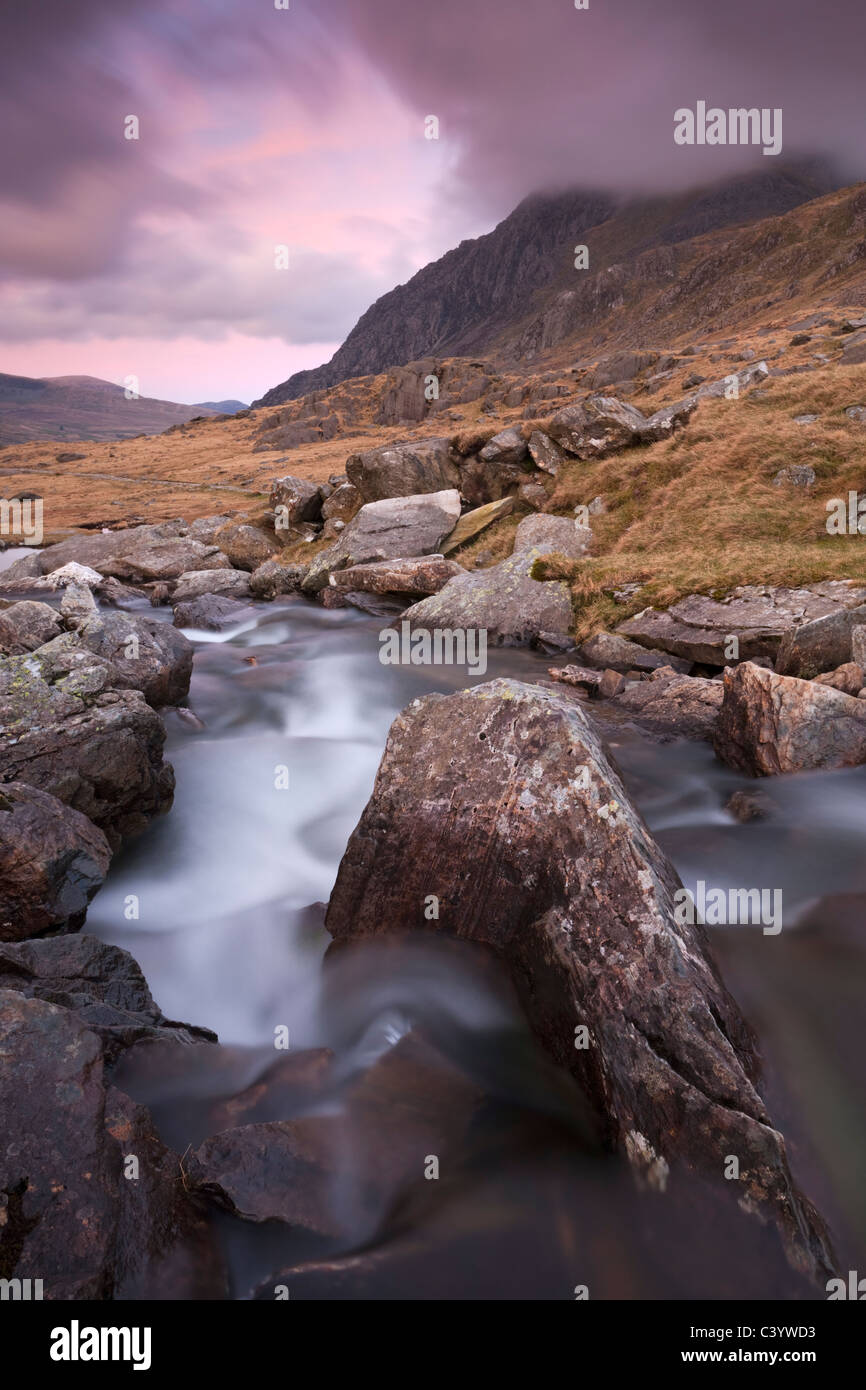 Rocky river in Cwm Idwal looking towards Tryfan at sunset, Snowdonia National Park, Conwy, Wales, UK. Spring (April) 2011. Stock Photo
