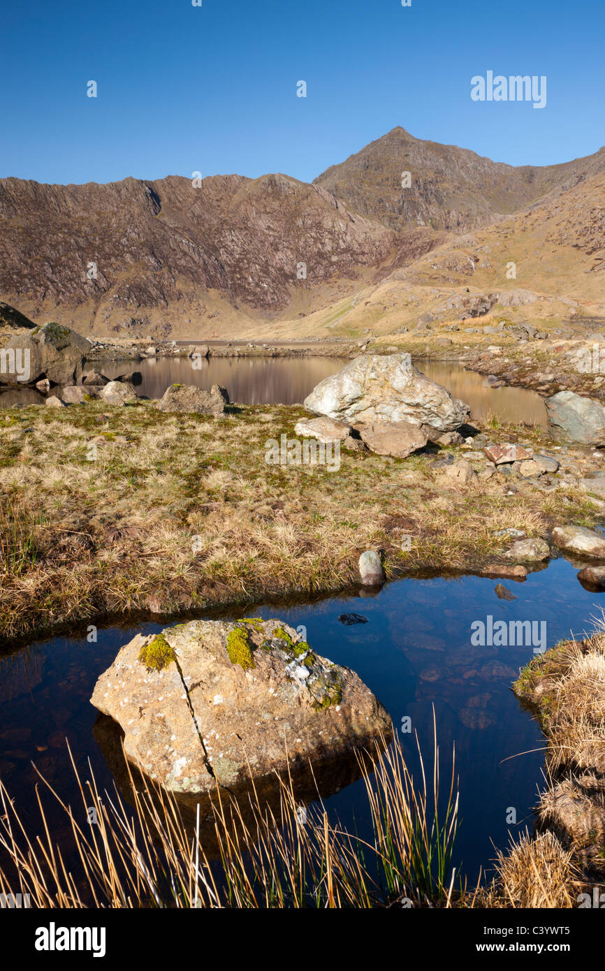 Mount Snowdon behind the rocky shores of Llyn Llydaw, Snowdonia National Park, Gwynedd, North Wales, UK. Spring (April) 2011. Stock Photo