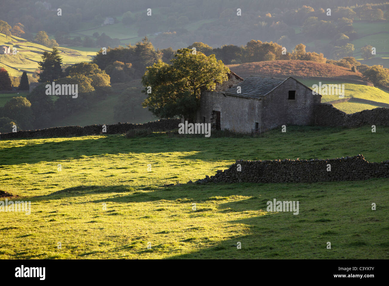 A solitary stone barn stands on the hills over Howgill in Wharfedale England Stock Photo