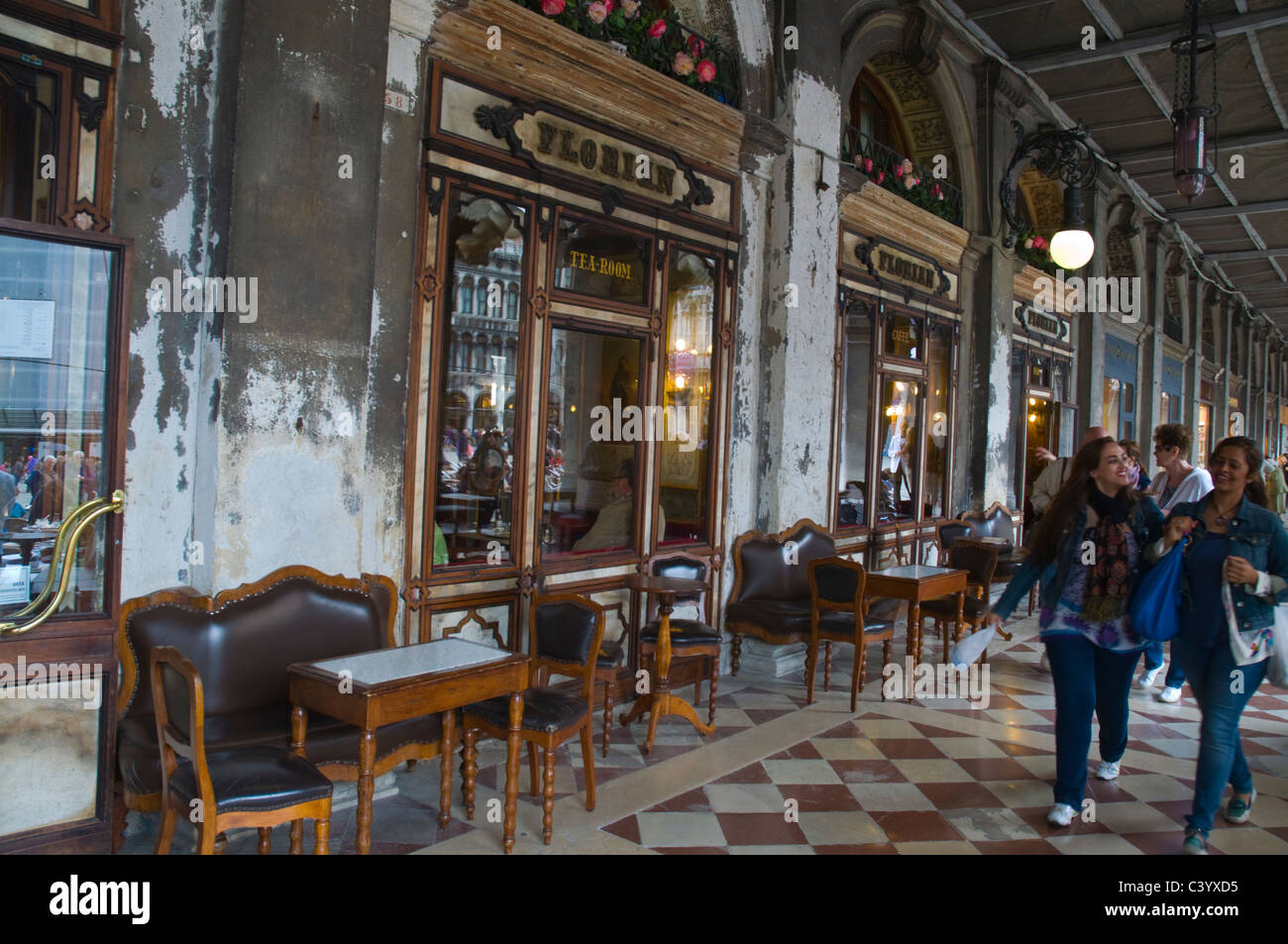 Tourists walking past Caffe Florian cafe Piazza San Marco square Venice ...