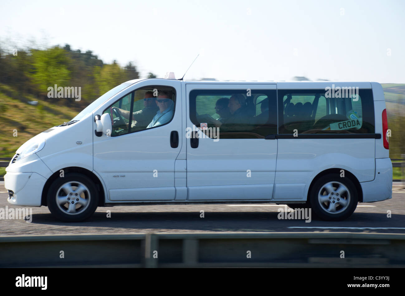 white mini bus on the motorway Stock Photo